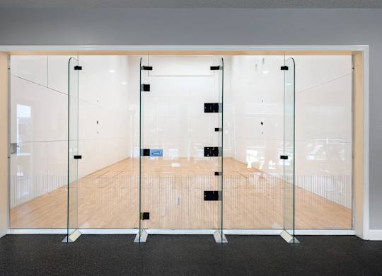 A room with a wooden floor and glass walls.