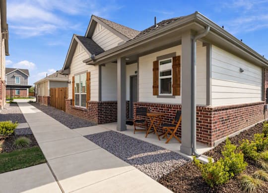A house with a white siding and a brown door.