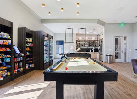 A billiard table is in the middle of a room with a pool table light.