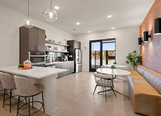 A modern kitchen with a bar area and a dining table.