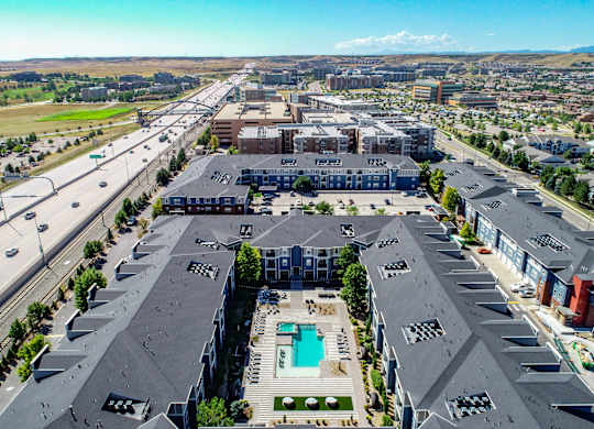 an aerial view of a city with buildings and a pool