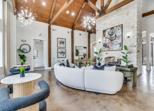a living room with couches and chairs and a fireplace