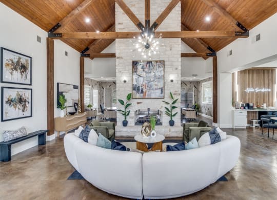 a living room with a large white couch and a fireplace