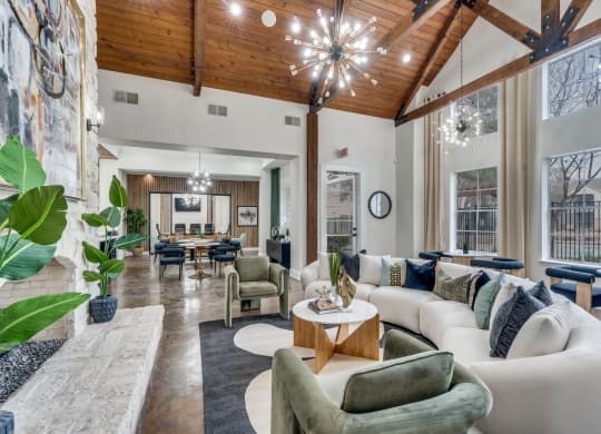 a living room with couches and chairs and a table