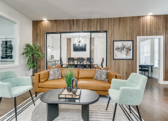 a living room with a couch and chairs and a table