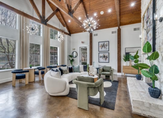 an open living room with large windows and furniture