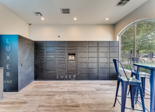 a bar with blue stools in front of a large metal locker door