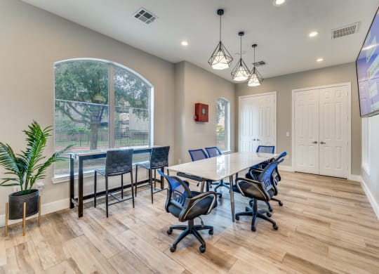 a conference room with a table and chairs and a large window