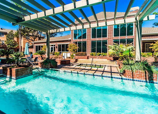 A swimming pool under a covered patio area.