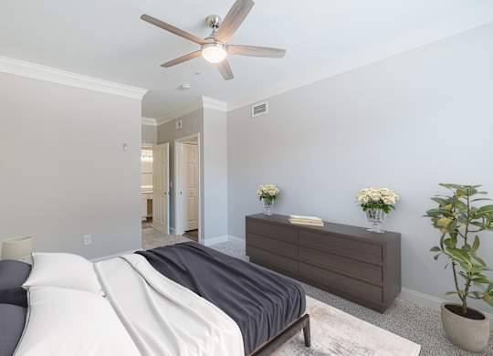 a bedroom with a bed and a ceiling fan
