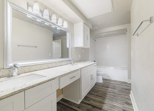 a bathroom with a large mirror and a sink and a toilet