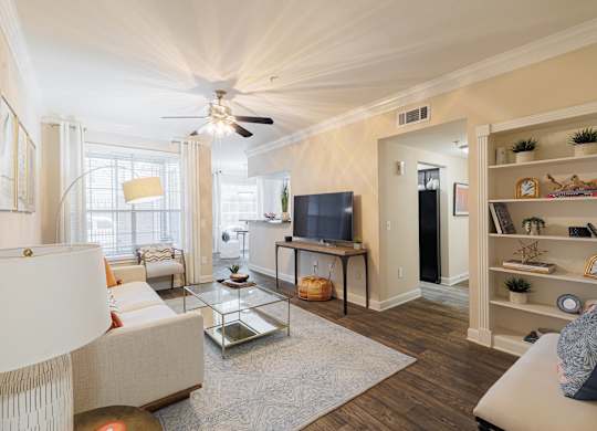 A living room with a white couch and a television.