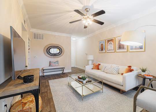 A living room with a white couch and a coffee table.