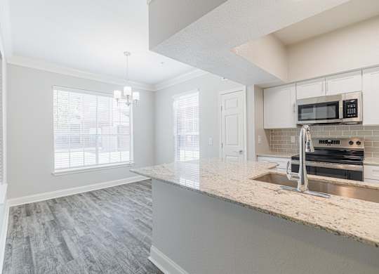 a kitchen with a marble counter top and a sink