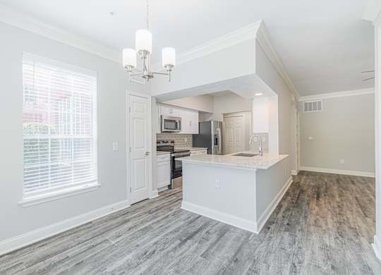 an open kitchen and living room with a large window