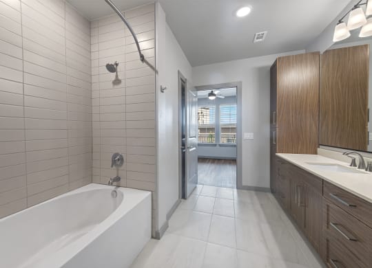 a bathroom with a tub and a sink and a shower
