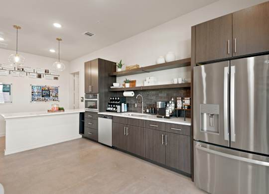 A modern kitchen with a stainless steel refrigerator and wooden cabinets.