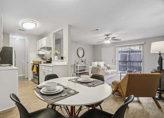A modern dining room with a white table and chairs.
