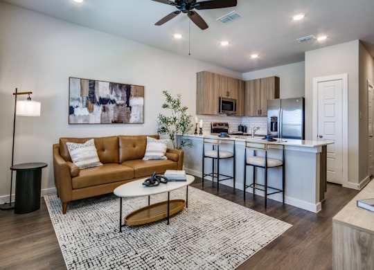 A modern living room with a brown sofa and a white coffee table.