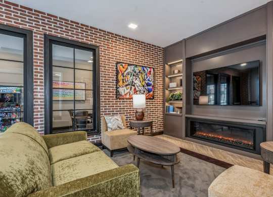 A living room with a fireplace and a painting on the wall.