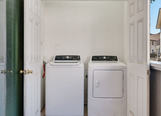 a washer and dryer in a laundry room with a door