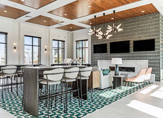A modern dining room with a wooden ceiling and a fireplace.