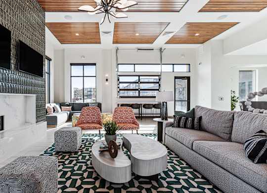 A modern living room with a fireplace and a large couch.