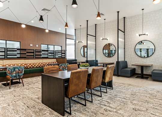 A modern dining area with a long table and chairs.
