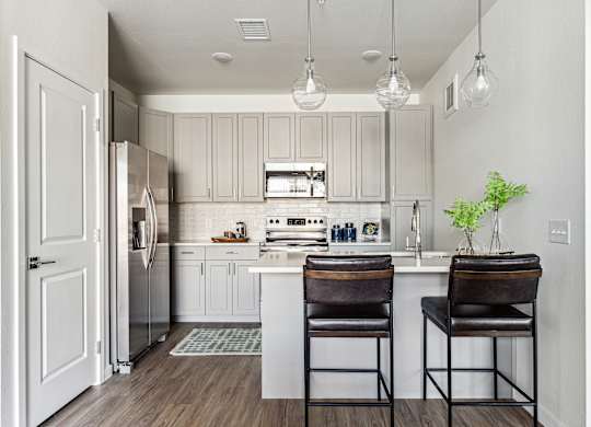 A kitchen with a white cabinet and a white fridge.