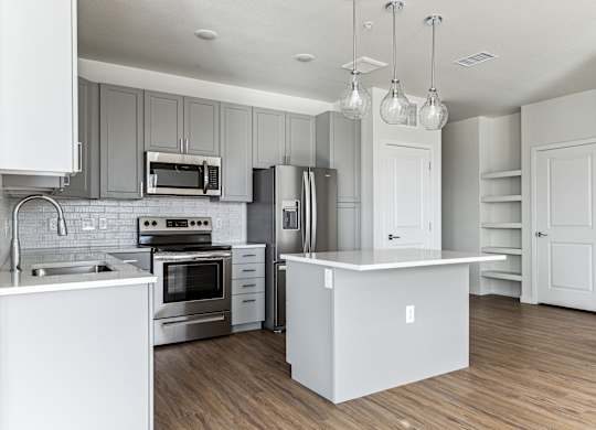 A modern kitchen with white appliances and cabinets.