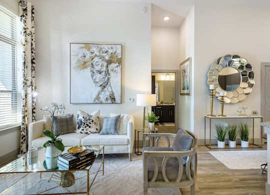 a living room with a couch and chairs and a table