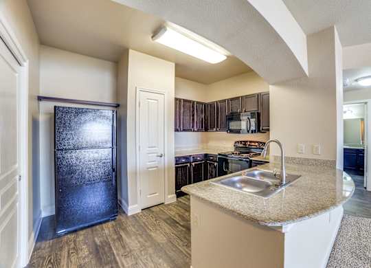 a kitchen with a sink and a refrigerator