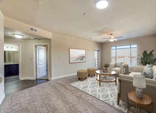 A well-lit living room with a rug, a sofa, and a coffee table.