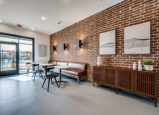 A room with a brick wall and a bench.
