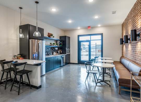 A modern kitchen with a dining area and a view of the outdoors.
