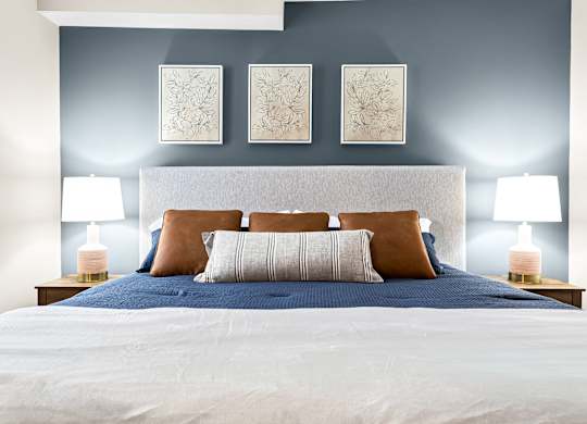 a bedroom with a bed and a blue wall