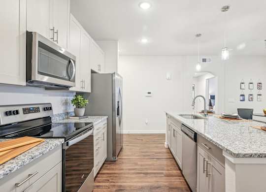 A kitchen with a stove top oven and a microwave above it.