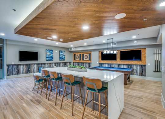 A bar area with a pool table and a TV.