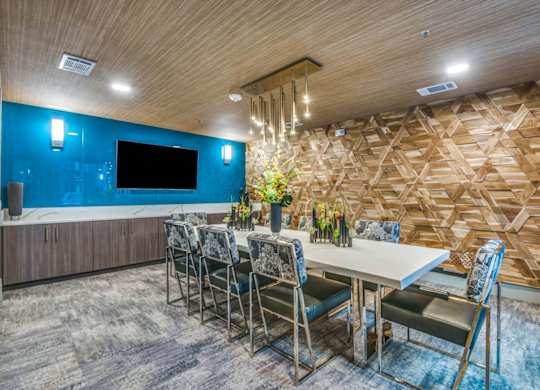 A dining room with a wooden wall and a TV.