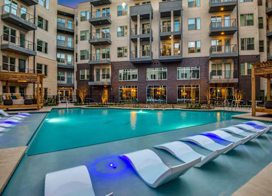 A large swimming pool with a blue light in the middle of it.