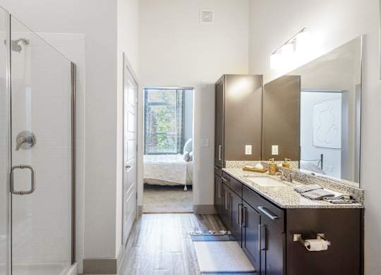a bathroom with a shower and a sink and a mirror