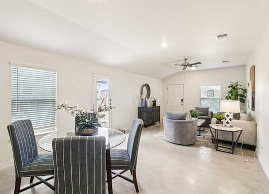 A dining room with a table and chairs.