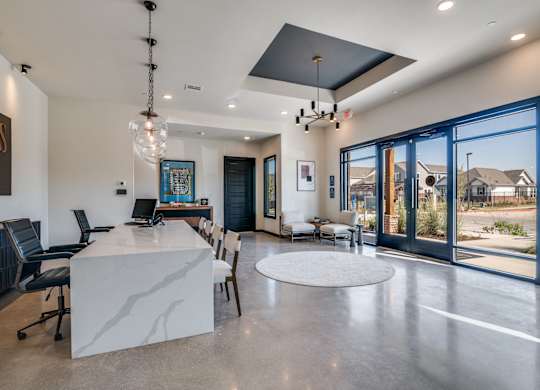 A modern home interior with a large kitchen island and dining area.