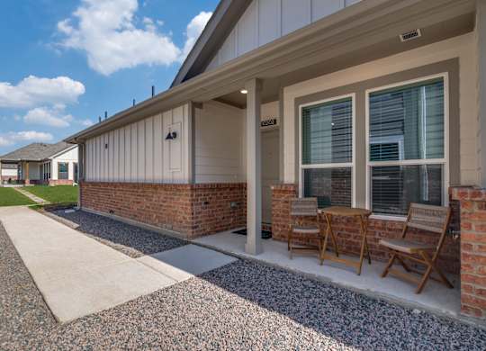 A house with a patio and chairs.