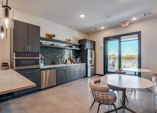 A modern kitchen with a dining table and chairs.