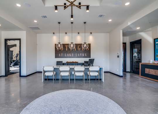 A modern dining room with a large table and chairs.