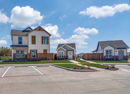 A row of houses with a large one in the middle.