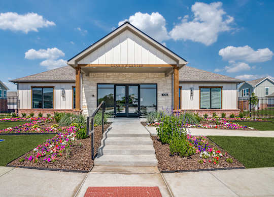 A building with a front yard and a sign that says "ENTRANCE".