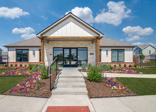 A building with a front yard and a sign that says "ENTRANCE".
