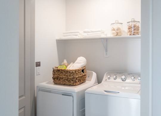 A small laundry room with a washer and dryer.